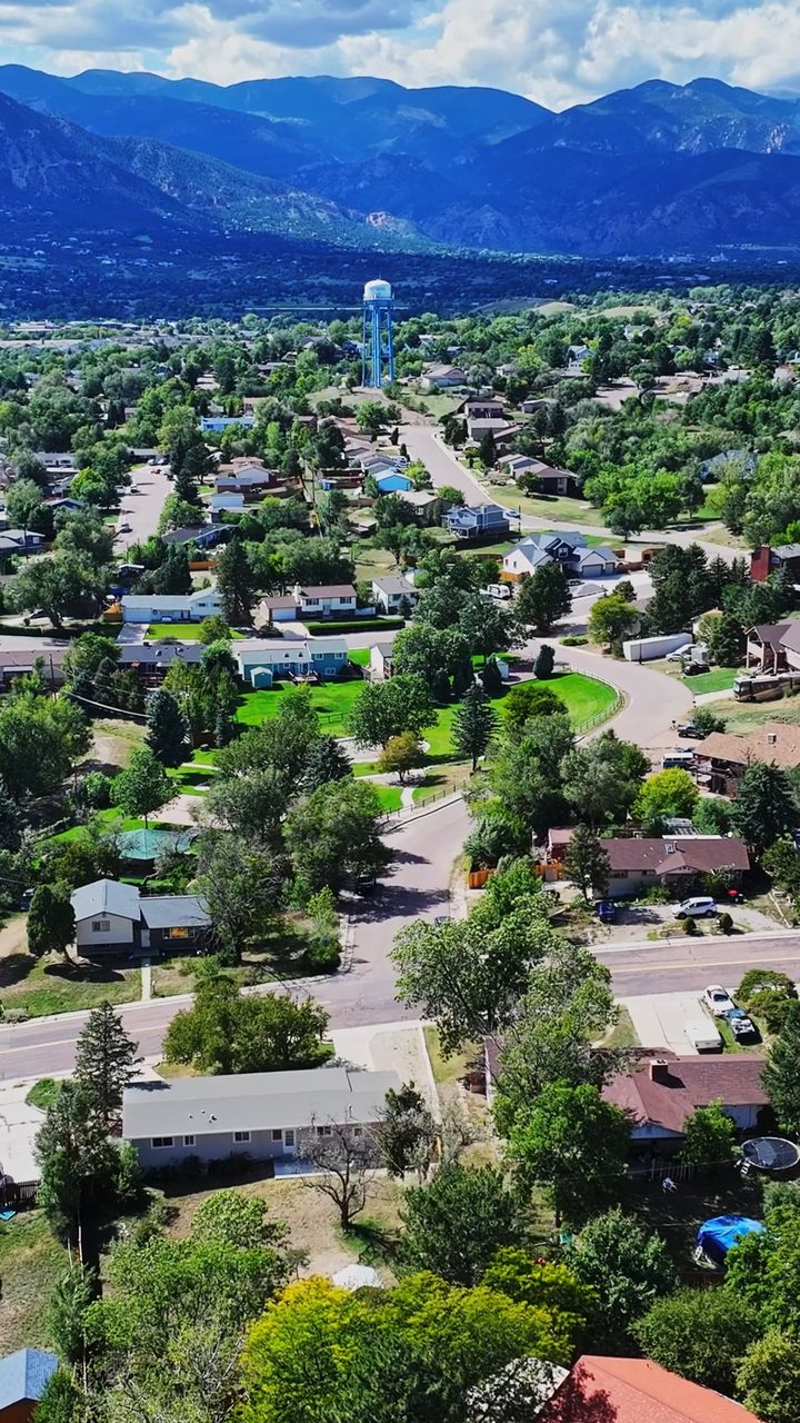 Aerial frame from the 609 Crestridge tour film, Cheyenne Mountain and the Front Range behind the neighborhood